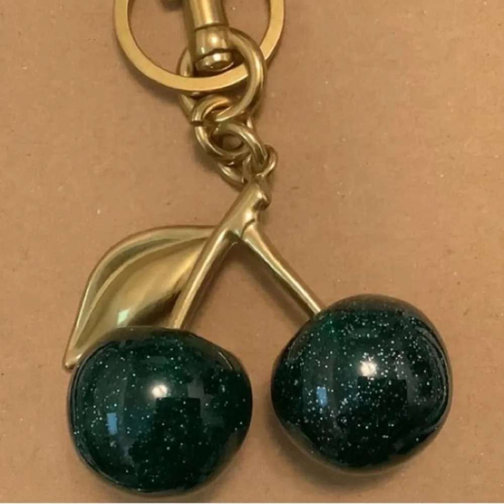Cherry bag charm in hunter green with sparkles and gold hardware